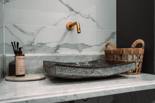 a bathroom with a stone sink on a counter at Villa Dolce in Silly