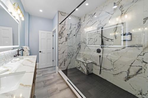 a bathroom with a walk in shower and a sink at The White Inn in Fredonia