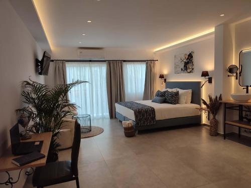a bedroom with a bed and some windows at Villa Nina Adult only in Skiathos