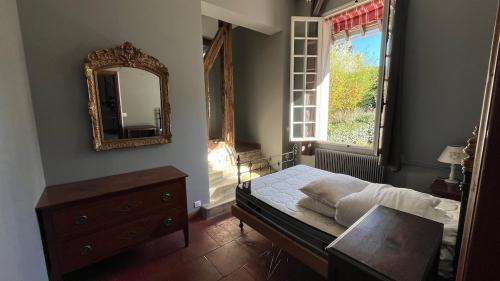 a bedroom with a bed and a mirror and a table at Le Chanoine - Centre Ville - Sens in Sens
