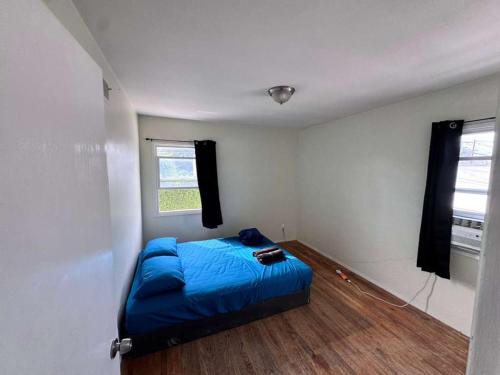 a bedroom with a blue bed and a window at La Cienega Near The Grove & Public Transit in Los Angeles