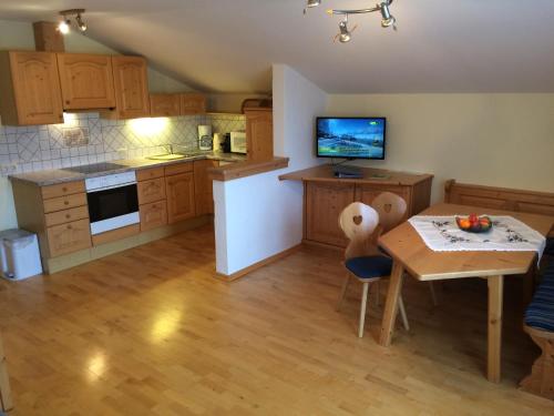 a kitchen with a table and a dining room at Urlpoldhof in Schladming