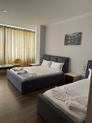 a hotel room with two beds and a window at Ikea hotel in Kashari