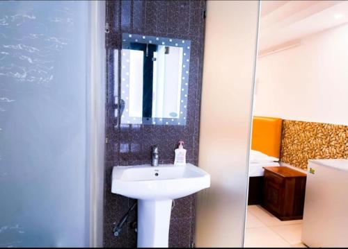 a bathroom with a sink and a mirror at Blueberry Residency - Hauz khas fort in New Delhi