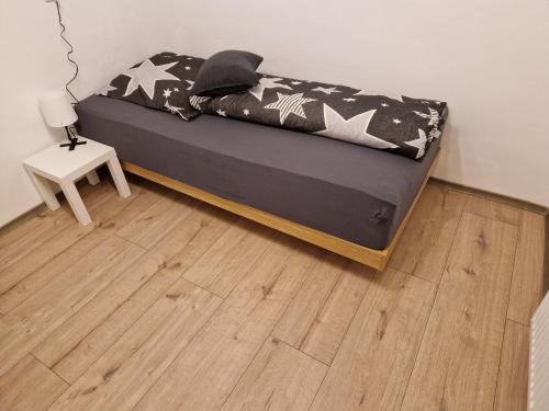 a bed in a room with a wooden floor at Herzstück in Grafenrheinfeld