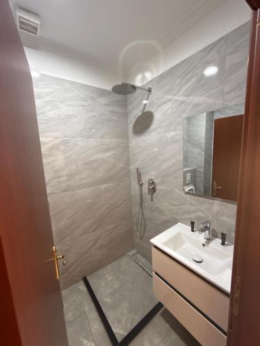 a bathroom with a sink and a mirror at Ikea hotel in Kashari