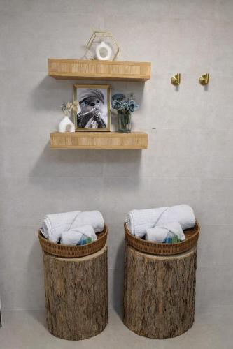 two wooden baskets with towels on a wall at Tomas Guesthouse in Lagodekhi