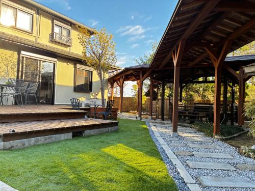 a patio of a house with a table and chairs at Biwako Villa 縁 in Takashima