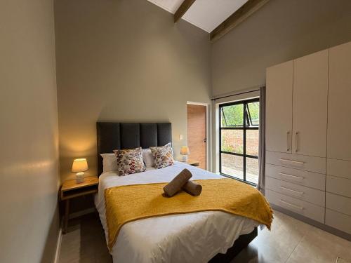 a bedroom with a bed with a towel on it at Autumn's Rest in George