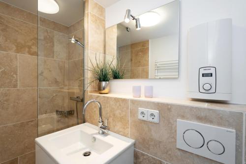 a bathroom with a sink and a mirror at Braderuper Heide in Braderup