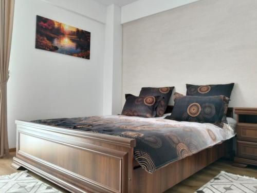 a bedroom with a bed in a room at GH Apartments 2 in Gura Humorului