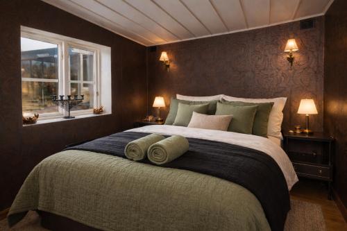 a bedroom with a large bed with two windows at Grynnan in Skå