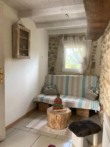 a living room with a couch and a table at Le Mafaté - Vallée de l'Eyrieux in Saint Maurice en Chalencon