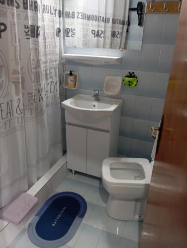 a small bathroom with a sink and a toilet at Akrata Golden Beach House 3 in Aíyira