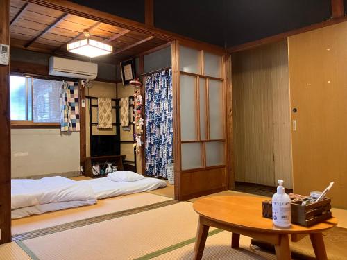a room with a bed and a table in it at wagaranchi in Kumano