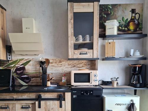 a kitchen with a stove and a microwave at ruhiger als im Hotel keine andere Gäste 3 Betten 2 Schlafzimmer in Merkendorf