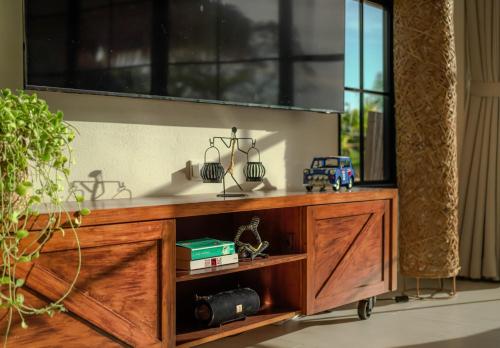 a wooden entertainment center with a large window at Fishman Beachfront Villas in Haad Pleayleam