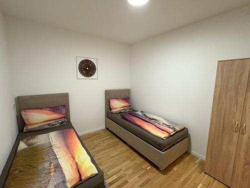two beds sitting in a room with at Apartament Modern Herne 3 in Herne