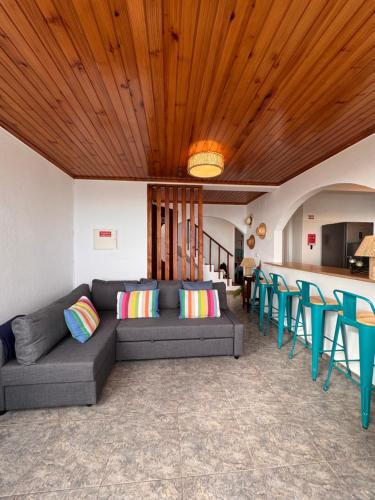 a living room with a couch and blue chairs at Lucky Jack in Jardim do Mar