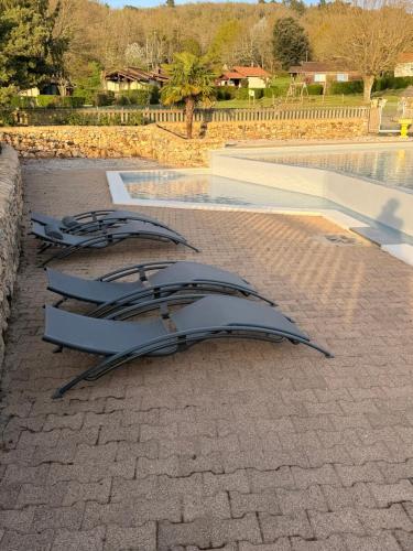a sculpture sitting on the ground next to a pool at Gîte de la Bastide de Domme in Domme