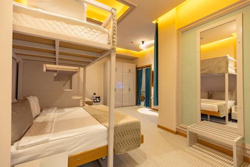a bedroom with two bunk beds in a room at National Hotel Ganja in Ganja