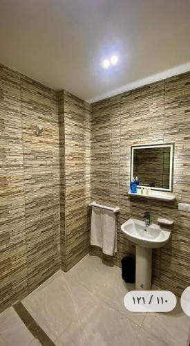 a bathroom with a sink and a window at Makan Pyramids View in Cairo
