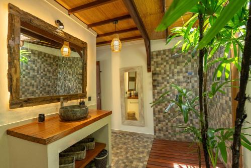 a bathroom with a sink and a mirror at Villa Pascaline in Mengwi