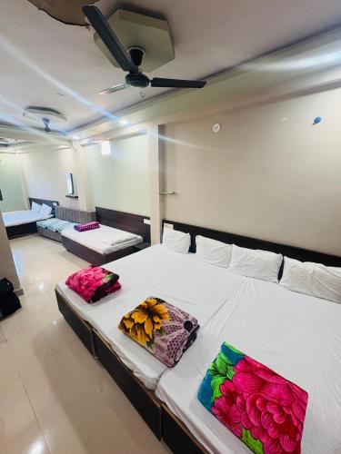 a room with a bed with flowers on it at Hotel Mukhiya Palace in Ujjain