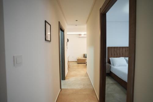 a hallway leading to a bedroom with a bed at Résidences Nador in Nador