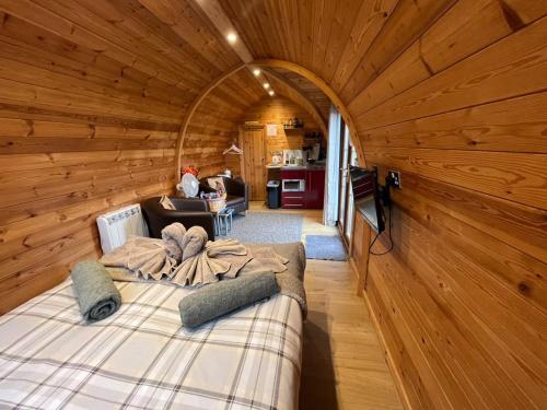 a room with a bed in a wooden cabin at Hatterall View Glamping Pod in Abergavenny