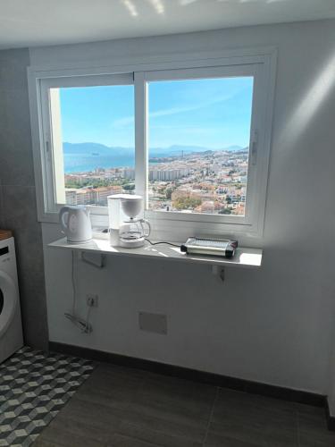 a window in a bathroom with a view of a city at Apartamento Bahía Sol in Rincón de la Victoria