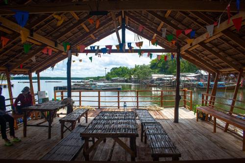 a group of benches on a dock with a marina at Krabi Floating Glamping in Ban Khlong Khae (2)