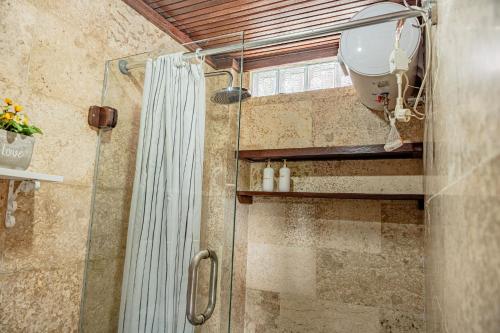 a shower in a bathroom with a shower curtain at Villa AMPO unique Gazebo Flat in Munggu