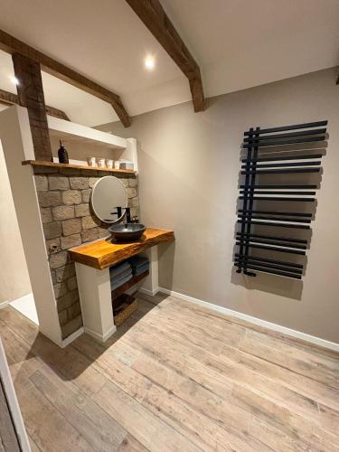 a bathroom with a mirror and a stone wall at Pothuis Zuid in Zandvoort