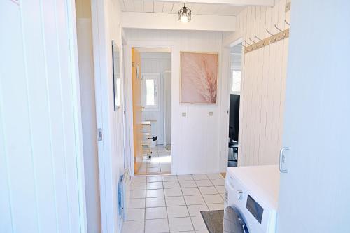 a kitchen with a hallway leading to a living room at Bork Cozy Cottage in Hemmet
