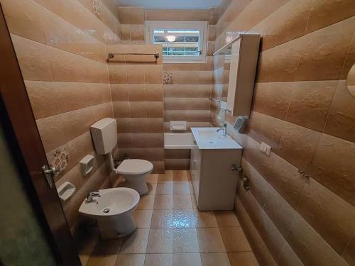 a bathroom with a toilet and a sink at Agata Agnese Homes in Carlazzo