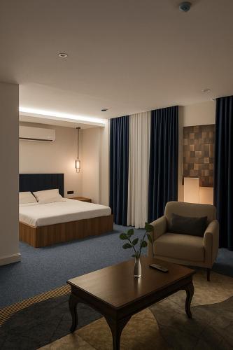 a hotel room with a bed and a coffee table at View Lounge Hotel in As Sulaymānīyah