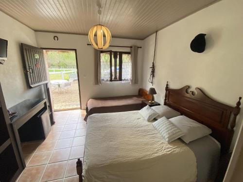 a bedroom with a bed in a room with a window at Auberge Marcheroux in Amboise