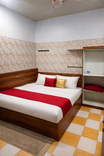 a bedroom with a large bed with red and yellow pillows at Hotel Vrindavan Near Prem Mandir Distance 15 min in Mathura
