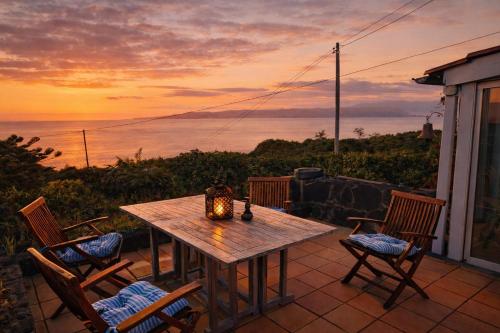 a table and chairs on a patio with a view of the ocean at Pico Sereno in Santana