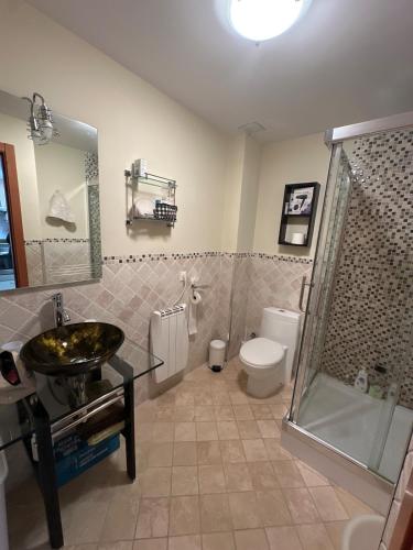 a bathroom with a sink and a shower and a toilet at Valdelinares 365 in Valdelinares