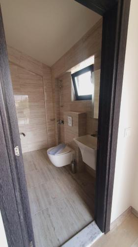 a bathroom with a tub and a toilet and a sink at Sunny Beach Potos in Potos