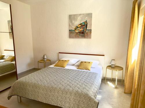 a bedroom with a bed and a painting on the wall at Apartments Maro in Senj