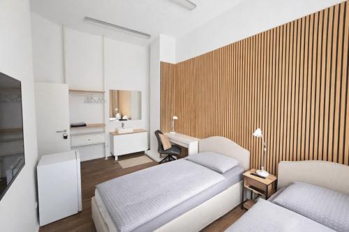 a hotel room with two beds and a desk at BASSWOOD ROOMS in Bremen