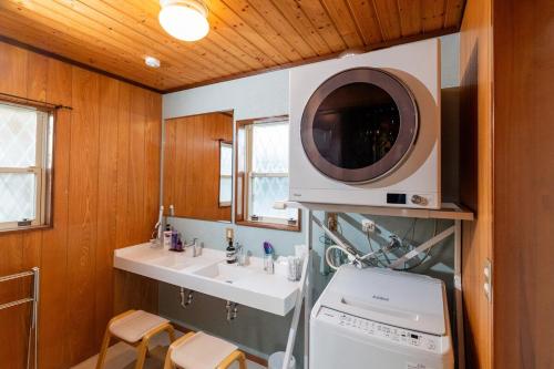 a kitchen with a sink and a microwave at Seasiders in Ichinomiya