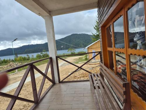 a porch of a house with a view of the water at cabañas liquidambar in La Trinitaria