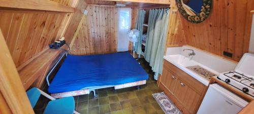 a small room with a blue bed in a kitchen at Elba Travels in Capoliveri