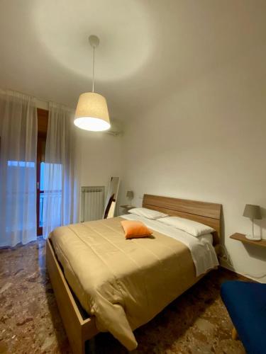 a bedroom with a bed with an orange pillow on it at Matteo's Home in Vietri sul Mare