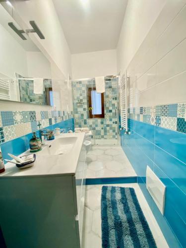 a blue and white bathroom with a sink and a mirror at Matteo's Home in Vietri sul Mare