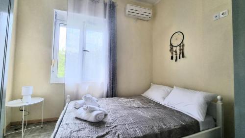 a bedroom with a bed with a clock on the wall at Julieta's house in Chios